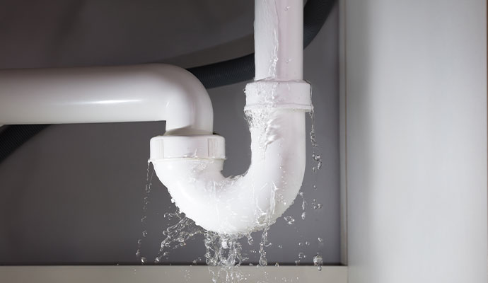 A white pvc pipe leaking water
