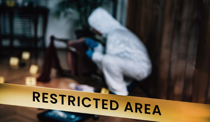 An expert performing biohazard cleanup in a restricted area