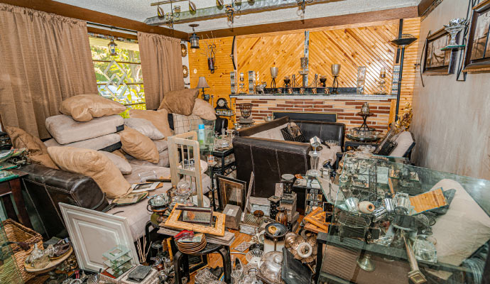 Hoarded room with excessive clutter and items Room severely affected by hoarding disorder, filled with excessive clutter and accumulated items