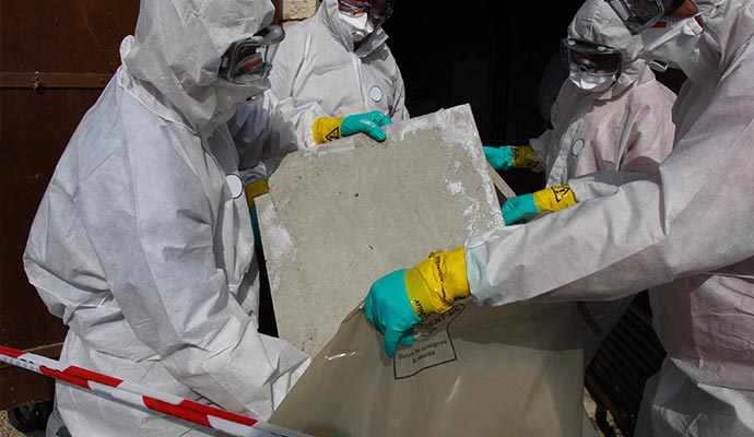 Hazmat team removing hazardous materials from a property