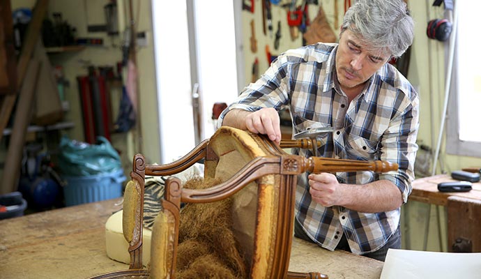 A person is restoring furniture