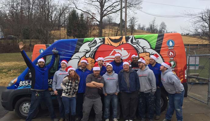 Crossroads Property Rescue's crew members with service vehicle