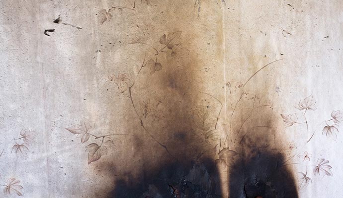 Smoke and soot damaged wallpaper