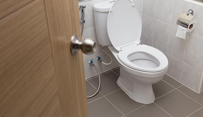 A spotless toilet in a modern, clean bathroom