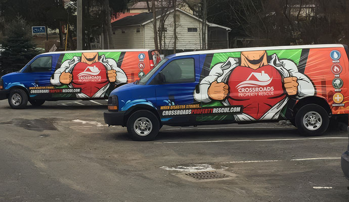 Crossroads Property Rescue emergency response service vans parked in a lot