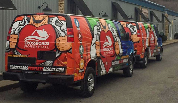 Two Crossroads Property Rescue service vans parked outside ready for emergency response
