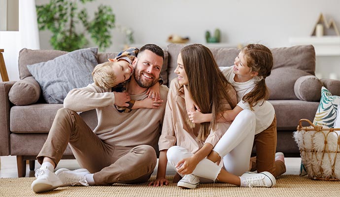 Happy family in a living room restored after flood damage